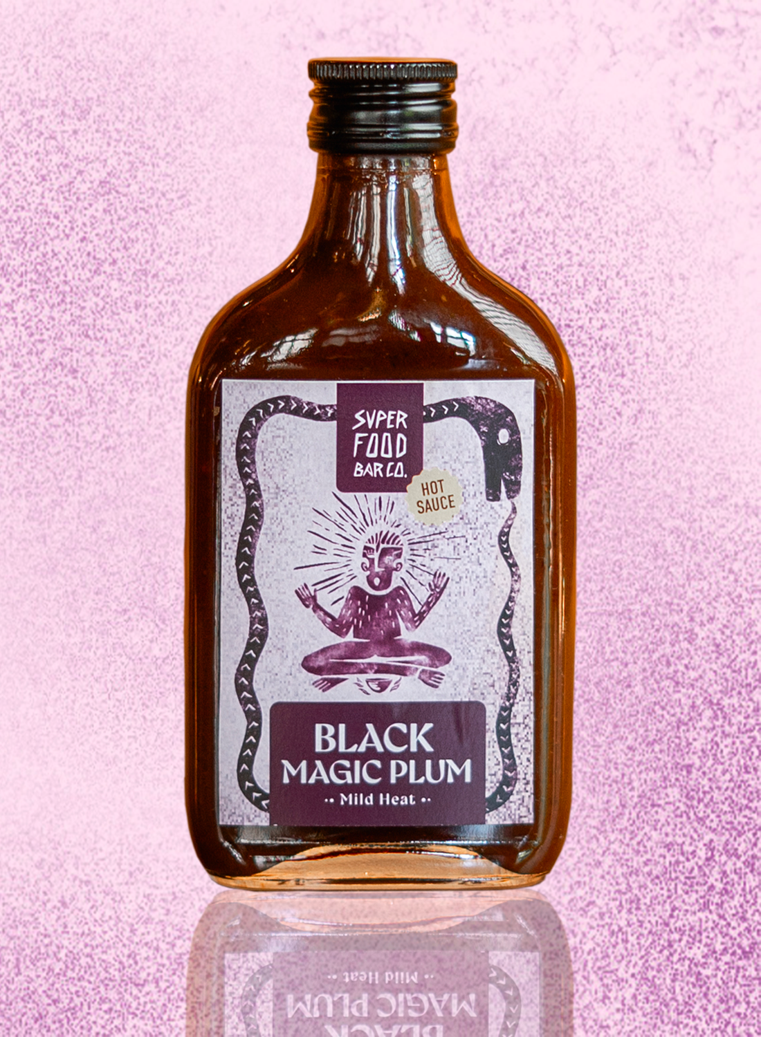 Black Magic Plum hot sauce bottle on a textured purple background