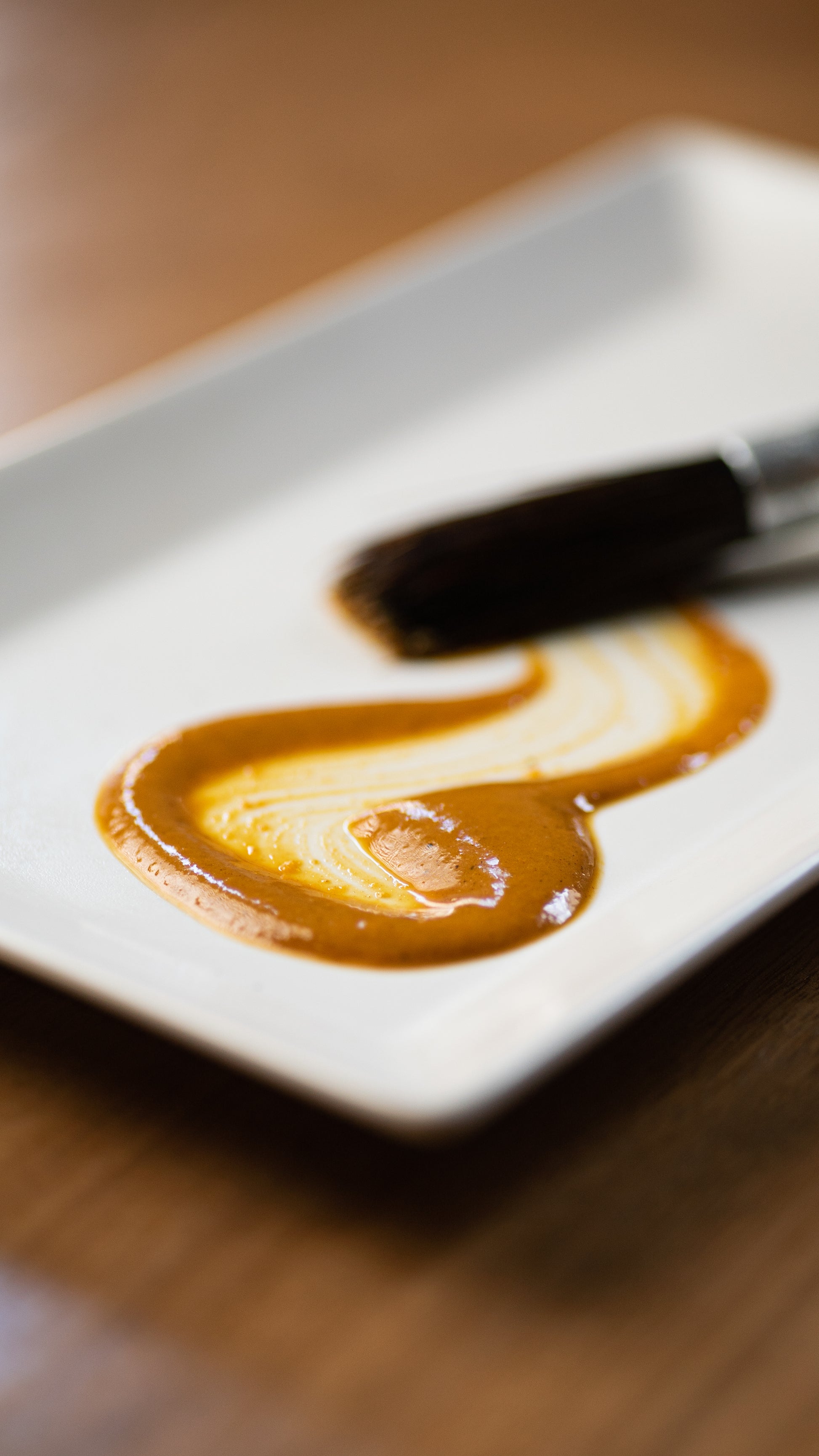 Golden Mango fermented hot sauce spread on a plate to show texture