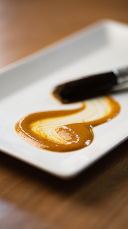 Golden Mango fermented hot sauce spread on a plate to show texture